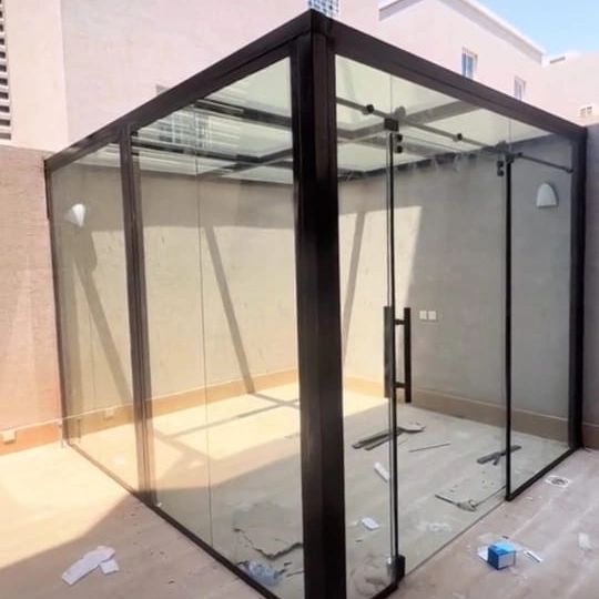 تصميم غرفة زجاجية خارجية لزيادة مساحة الاسترخاء في الحديقة